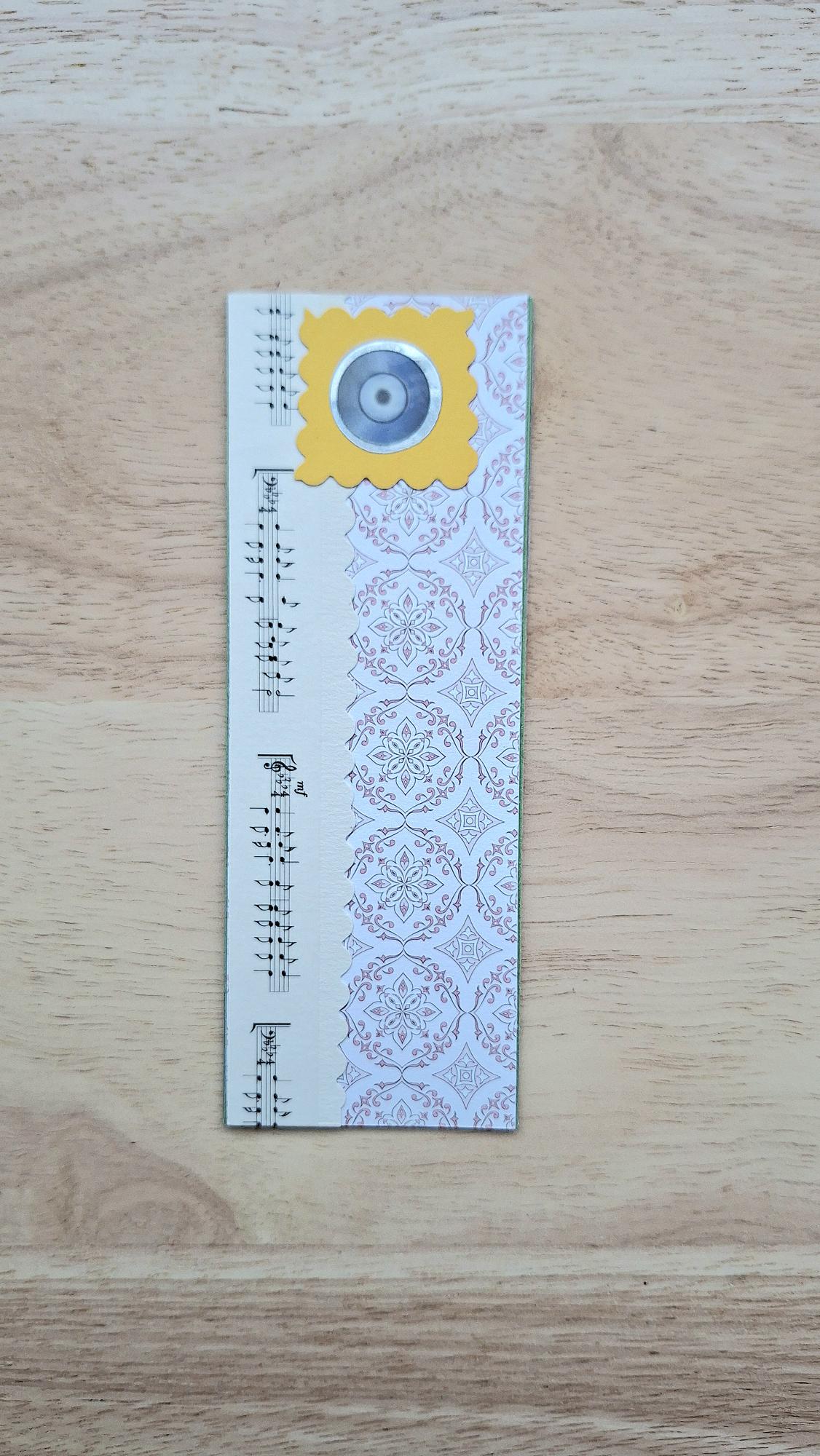 Vintage-style music bookmark with musical notes and a record in a yellow scalloped frame.