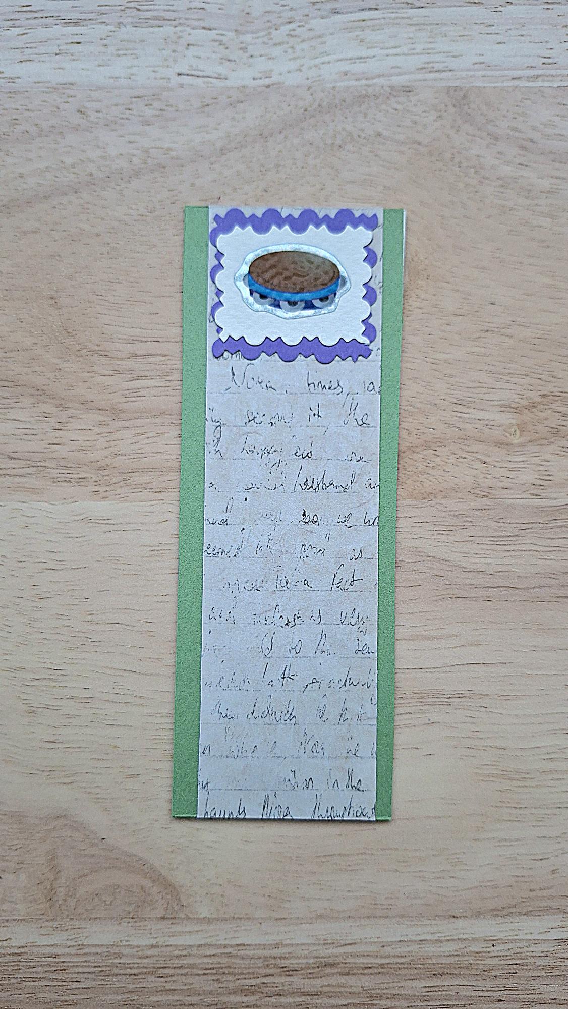Tambourine bookmark front with purple scalloped frame, green borders and vintage-style handwriting.