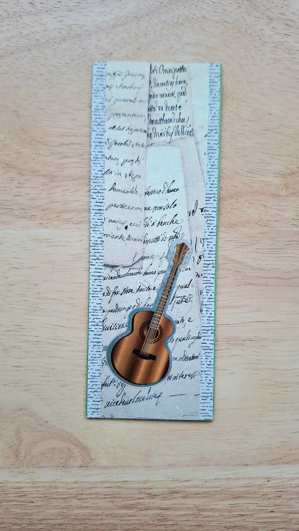 Handmade acoustic guitar bookmark with layered vintage handwriting, the cover of the Music Lovers collection.