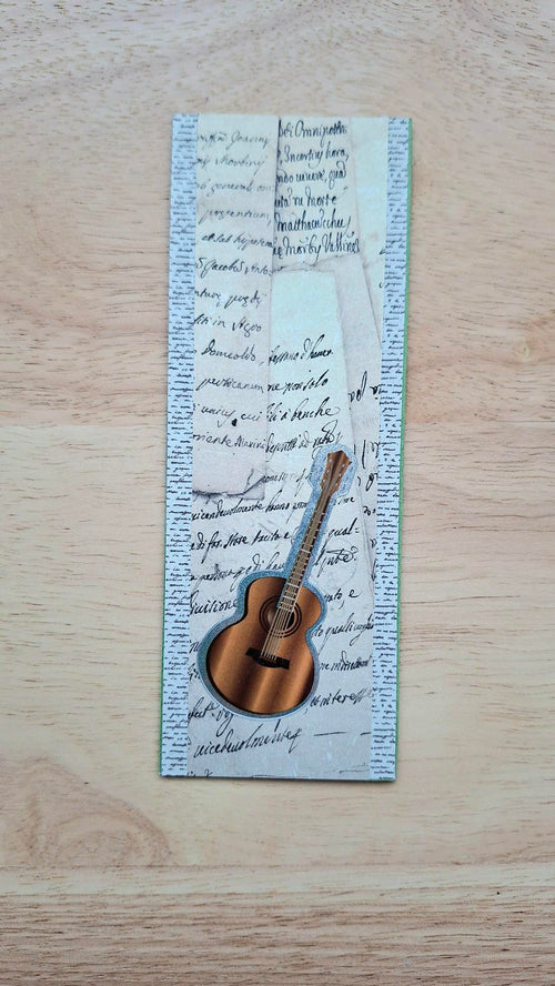 Handmade acoustic guitar bookmark with layered vintage handwriting, the cover of the Music Lovers collection.