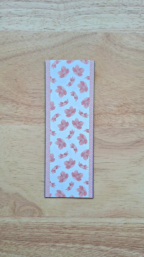 Bookmark reverse with dusty-pink flowers on a pale background and patterned borders.